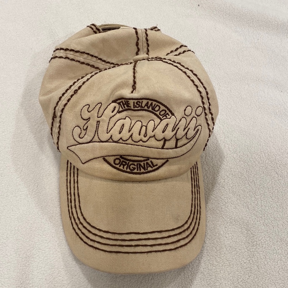 Cap with Hawaii stitched. Like new. Velcro for sizing. Beige and brown